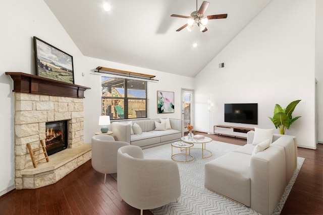 living room with hardwood / wood-style floors, ceiling fan, a fireplace, and high vaulted ceiling