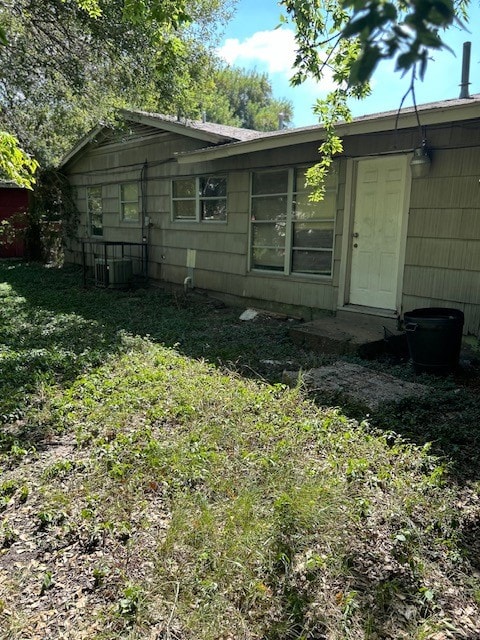 rear view of house featuring central AC unit