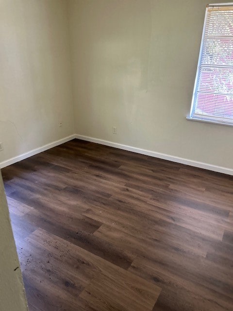 spare room with dark hardwood / wood-style floors