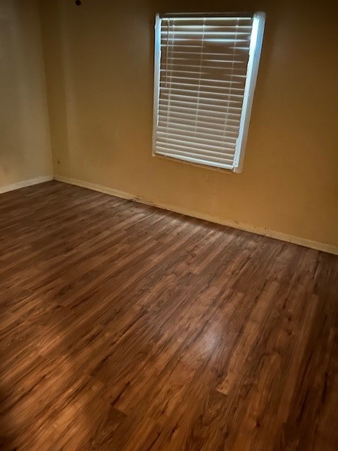 empty room with dark wood-type flooring