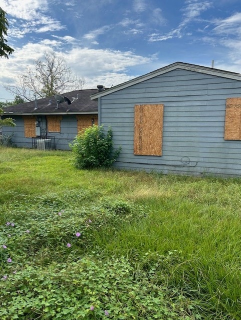 view of side of home featuring a yard