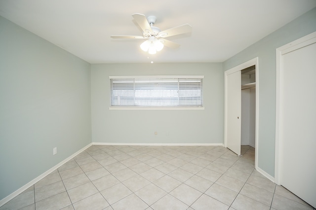 unfurnished bedroom featuring ceiling fan, a closet, and light tile patterned floors