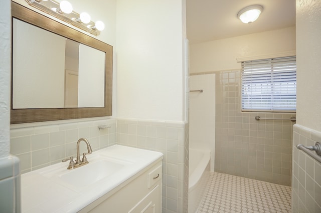 bathroom featuring vanity and tile walls