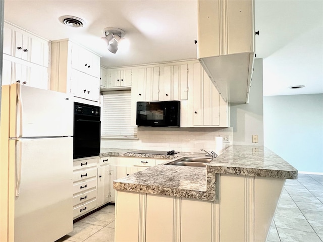 kitchen featuring kitchen peninsula, light tile patterned floors, sink, and black appliances