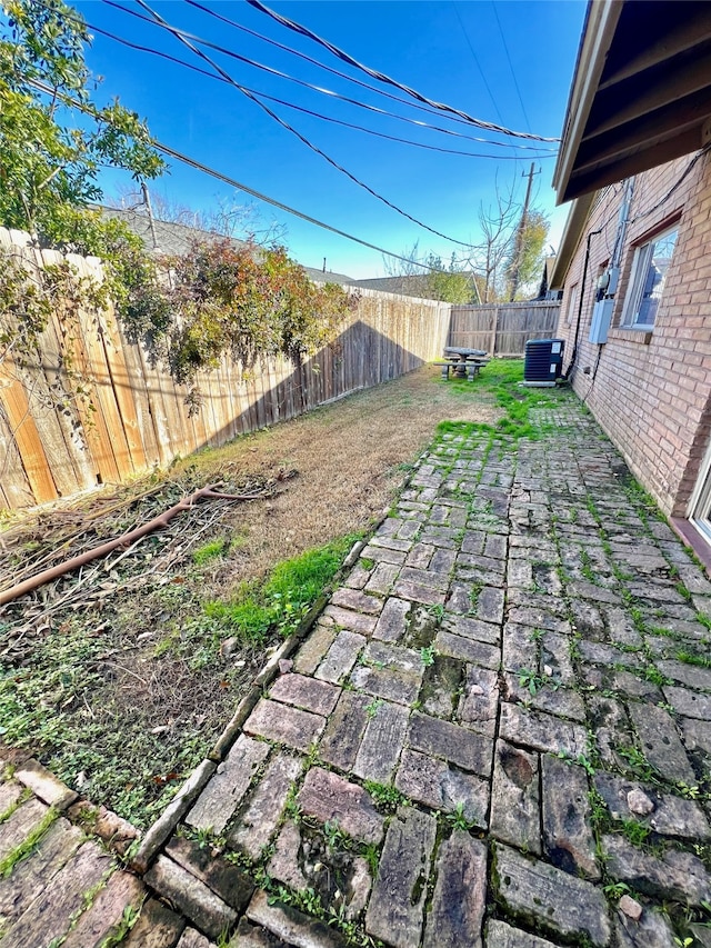 view of yard with a patio and central AC