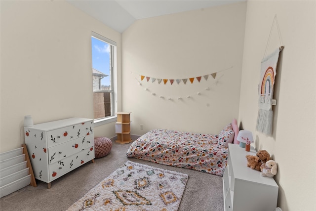 carpeted bedroom with lofted ceiling