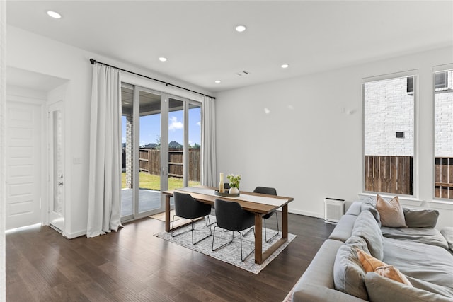 dining space with dark hardwood / wood-style flooring