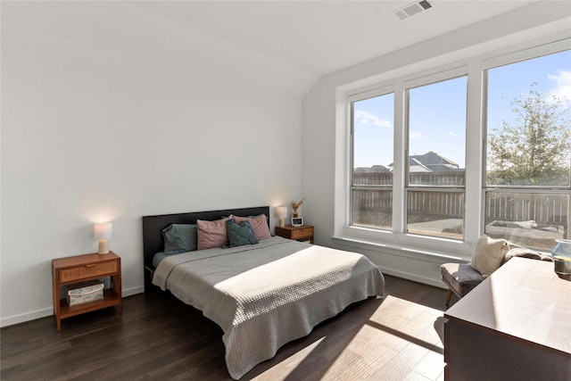 bedroom featuring vaulted ceiling and dark hardwood / wood-style floors