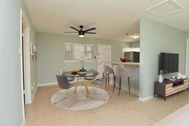 tiled dining room featuring ceiling fan