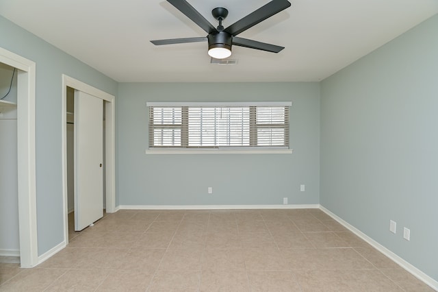 unfurnished bedroom with ceiling fan and light tile patterned floors