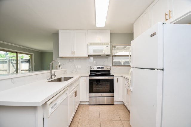 kitchen with ornamental molding, white appliances, sink, light tile patterned floors, and white cabinetry