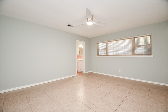 spare room featuring light tile patterned floors and ceiling fan