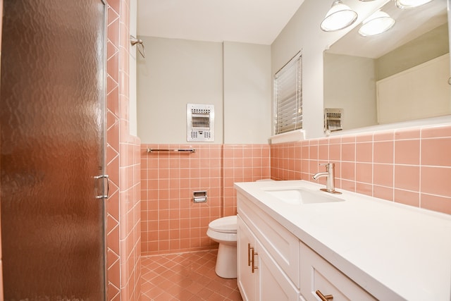 bathroom featuring walk in shower, tile patterned floors, toilet, vanity, and tile walls