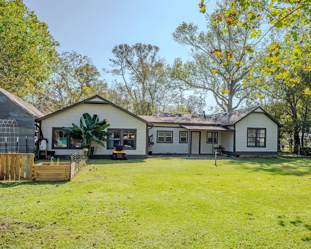 rear view of house with a yard