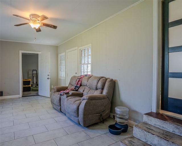 living room featuring ceiling fan, crown molding, and light tile patterned floors