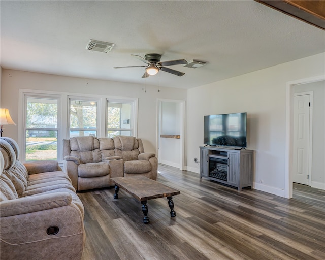 living room with ceiling fan and dark hardwood / wood-style floors