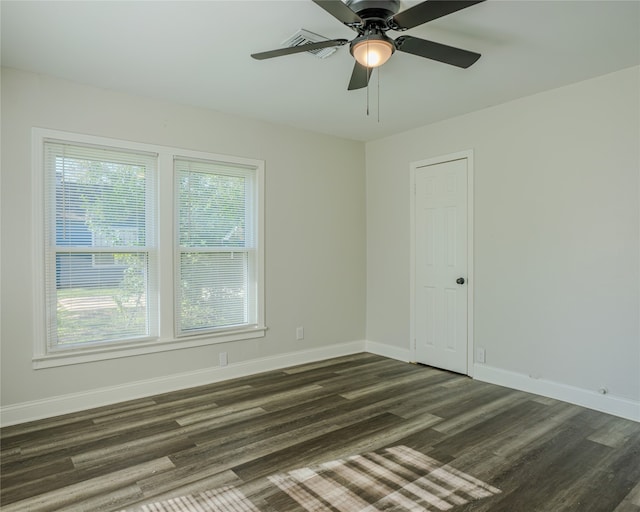 unfurnished room featuring ceiling fan and dark wood-type flooring