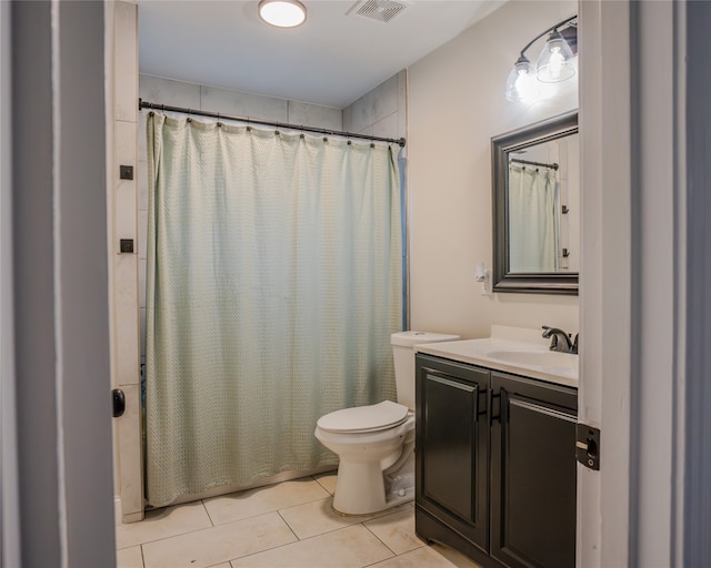 bathroom with curtained shower, tile patterned floors, vanity, and toilet