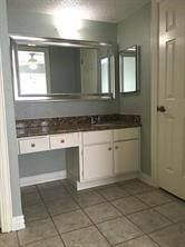 bathroom with tile patterned floors and vanity