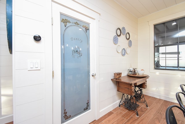 interior space featuring wood walls and hardwood / wood-style flooring