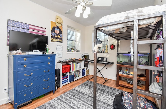 bedroom with hardwood / wood-style flooring and ceiling fan