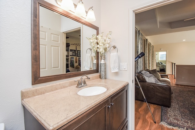 bathroom with hardwood / wood-style floors and vanity