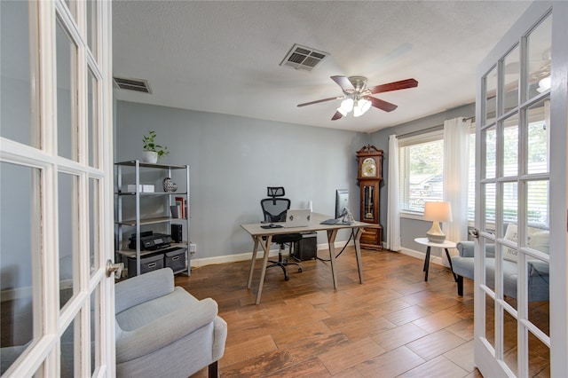 office space with french doors, a textured ceiling, ceiling fan, and hardwood / wood-style floors