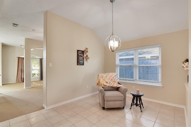 sitting room with light tile patterned flooring, a healthy amount of sunlight, and an inviting chandelier