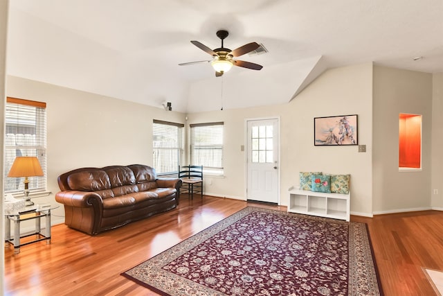 living room with ceiling fan, hardwood / wood-style floors, and lofted ceiling