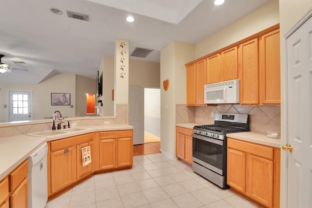 kitchen featuring ceiling fan, sink, light tile patterned floors, and white appliances