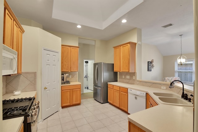 kitchen featuring sink, stainless steel appliances, tasteful backsplash, a notable chandelier, and pendant lighting