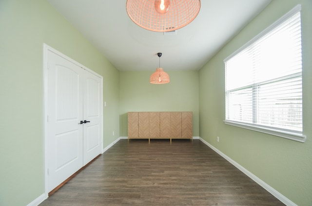 unfurnished dining area with dark hardwood / wood-style flooring