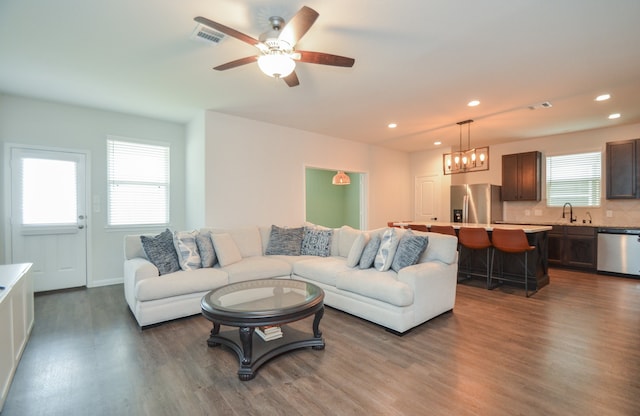 living room with ceiling fan, sink, and dark hardwood / wood-style floors