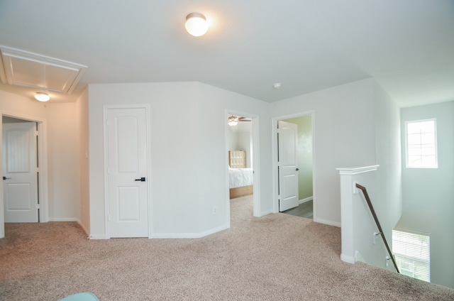 interior space featuring light carpet and multiple windows