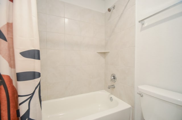 bathroom with shower / bath combination with curtain and toilet