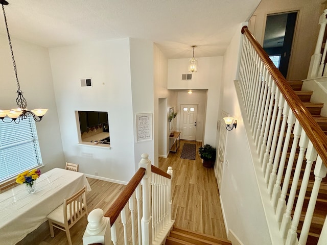 foyer featuring light hardwood / wood-style flooring and a notable chandelier