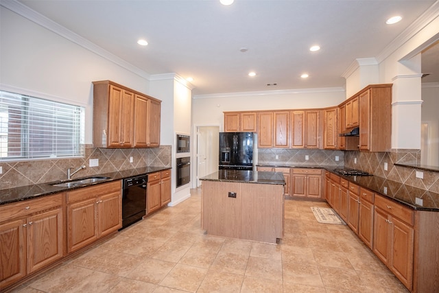 kitchen with a center island, black appliances, crown molding, sink, and dark stone countertops