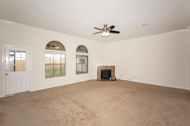 unfurnished living room with crown molding, a fireplace, and carpet