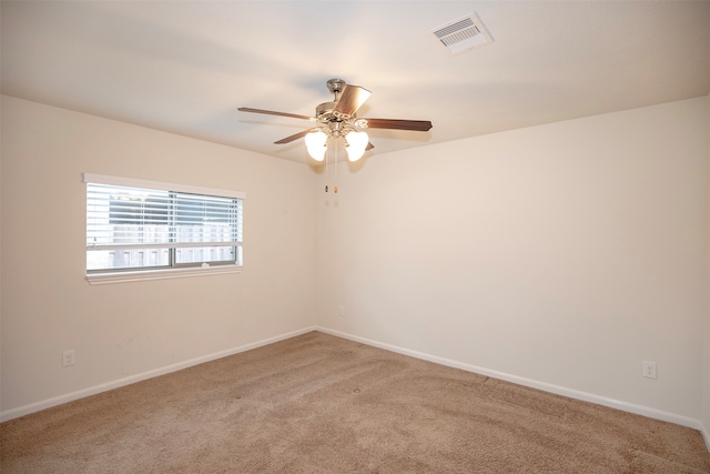 carpeted spare room with ceiling fan