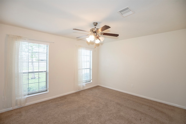 empty room with ceiling fan and carpet floors