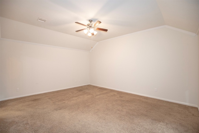 unfurnished room with carpet flooring, ceiling fan, ornamental molding, and vaulted ceiling