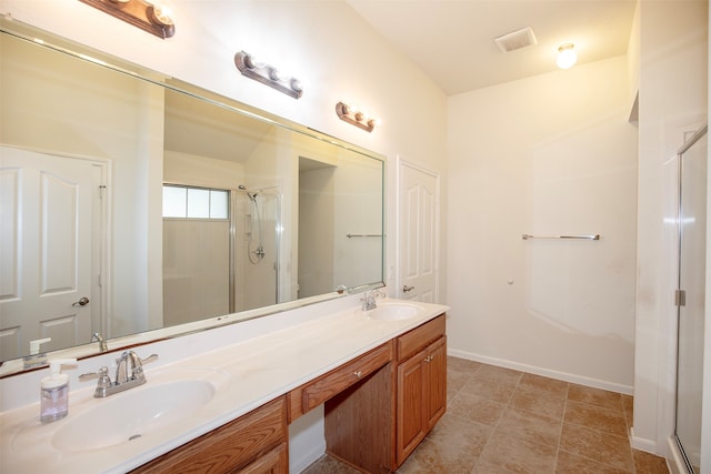 bathroom with tile patterned floors, vanity, and a shower with shower door