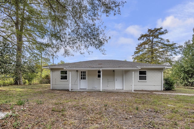 back of property featuring a yard