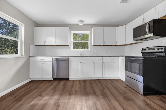 kitchen featuring white cabinets, dark wood-type flooring, and appliances with stainless steel finishes