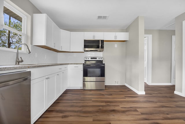 kitchen featuring white cabinets, dark hardwood / wood-style flooring, and stainless steel appliances