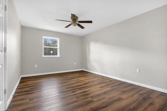 spare room with dark hardwood / wood-style floors and ceiling fan