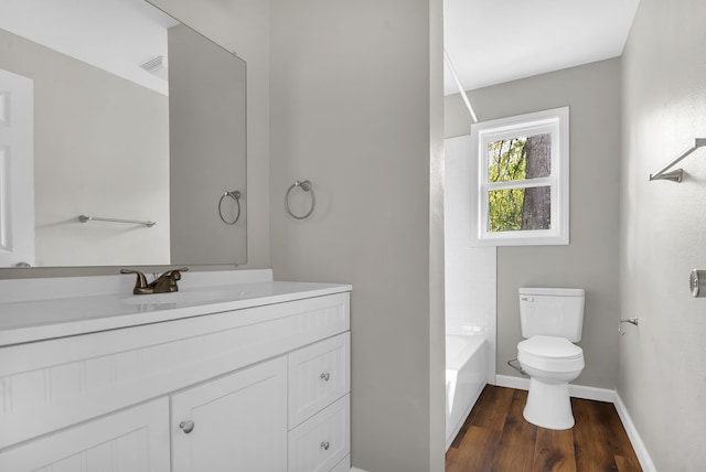 full bathroom featuring toilet, vanity, tub / shower combination, and hardwood / wood-style flooring