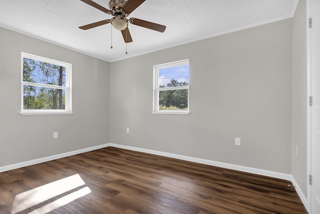 empty room with ceiling fan, dark hardwood / wood-style flooring, and ornamental molding