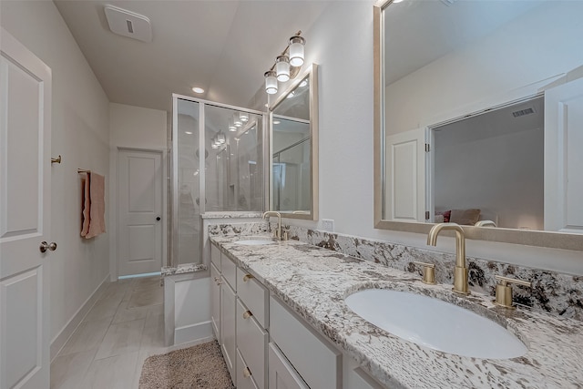 bathroom with tile patterned floors, vanity, and a shower with shower door