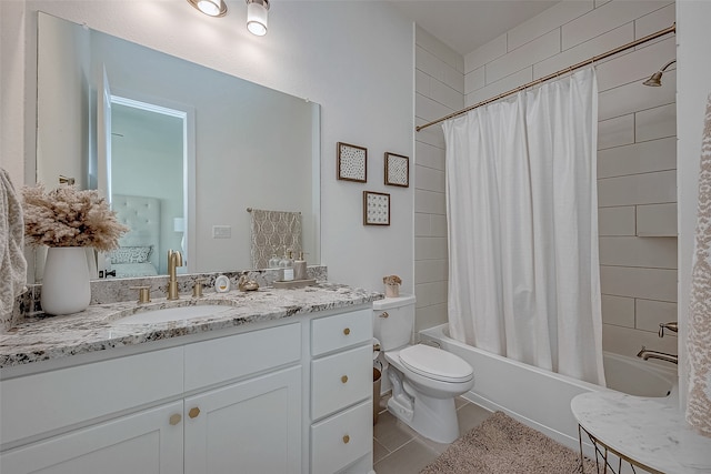 full bathroom featuring tile patterned floors, shower / tub combo with curtain, vanity, and toilet